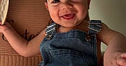 Easton Hanrahn joined the competition — help win amazing prizes! baby, smiling, denim_overalls, child, infant, happy, cute, portrait, sitting, hand, foot, cozy, blanket, indoors, young_child, face, skin, expression, milestone, text_overlay