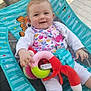 baby, smiling, child, toy, baby_chair, outdoor, colorful, playful, happy, infant, clothing, seat, fabric, pattern, hand, face, cute, comfort, sunlight, playtime