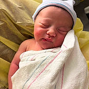 Liliana is registered to the contest to win money with this photo: newborn, baby, infant, sleeping, swaddled, hospital, receiving_blanket, knit_hat, soft_towel, chubby_cheeks, closed_eyes, pursed_lips, hand, bare_shoulder, skin, hospital_bed, medical_equipment, peaceful, portrait, newborn_room