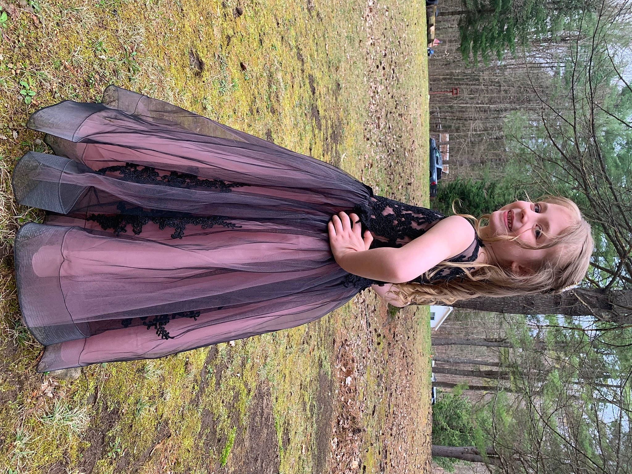 Layla is registered to the contest to win money with this photo: art, dress, elbow, fun, grass, grassland, happy, human_leg, joy, landscape, leisure, people_in_nature, person, plant, smile, tree, trunk, waist, wood