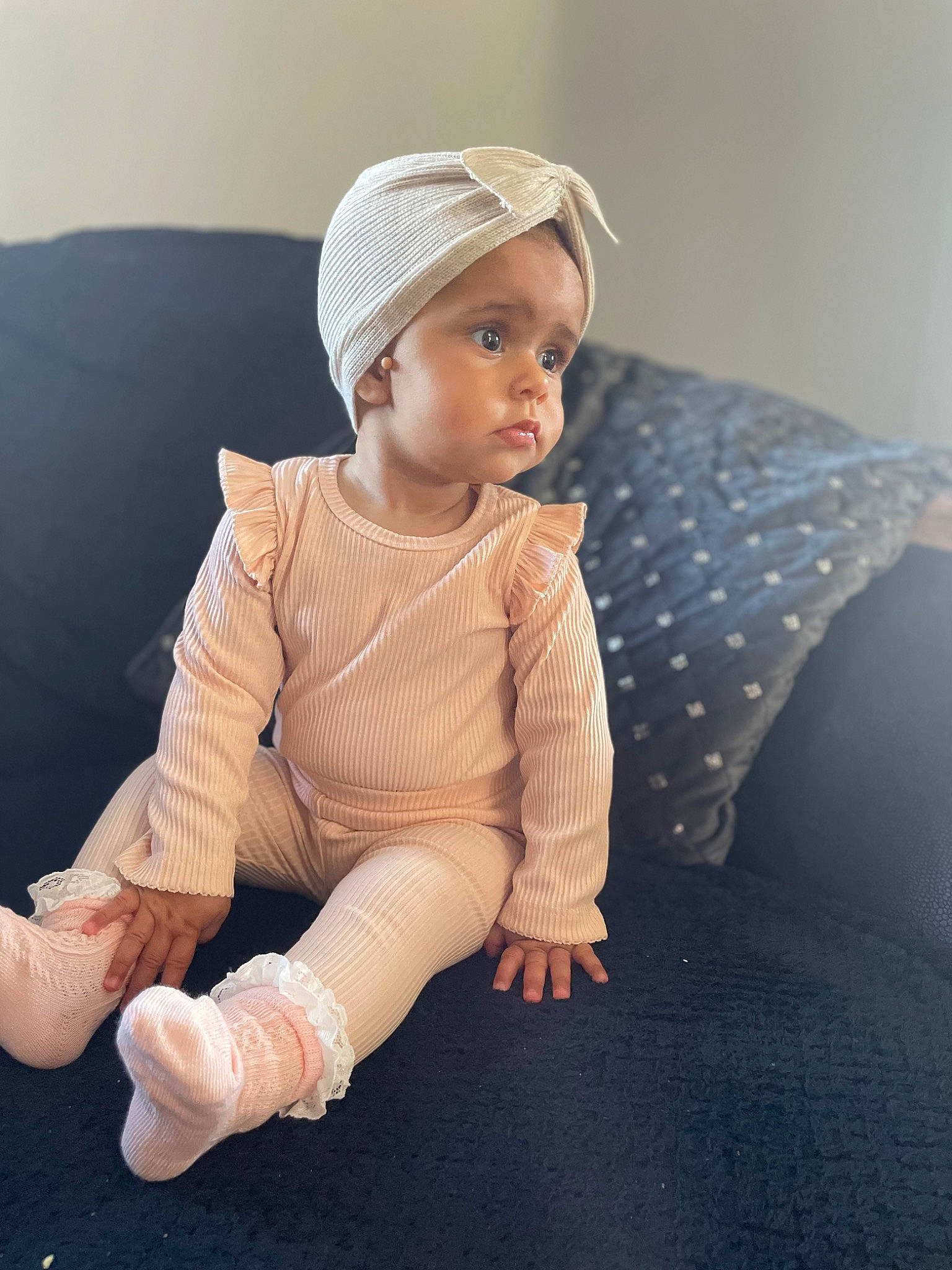 Giana is registered to the contest to win money with this photo: baby, baby_toddler_clothing, barefoot, cap, comfort, elbow, flooring, fun, headgear, headwear, human_body, human_leg, knee, leg, outerwear, pattern, person, skin, sleeve, sock