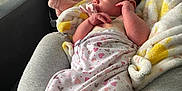 Elena is registered to the contest to win money with this photo: newborn, baby, swaddle, pacifier, blanket, cushion, sofa, footprint_pattern, heart_pattern, indoor, infant, resting, comfort, soft_toys, fabric, child, person, portrait, relaxation, cute