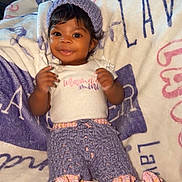 Lavender joined the competition — help win amazing prizes! baby, infant, smiling, knit_hat, knit_pants, blanket, portrait, child, shoes, cute, cozy, hands, eyes, picture_frame, photograph, home_interior, fabric, sitting, outfit, happy