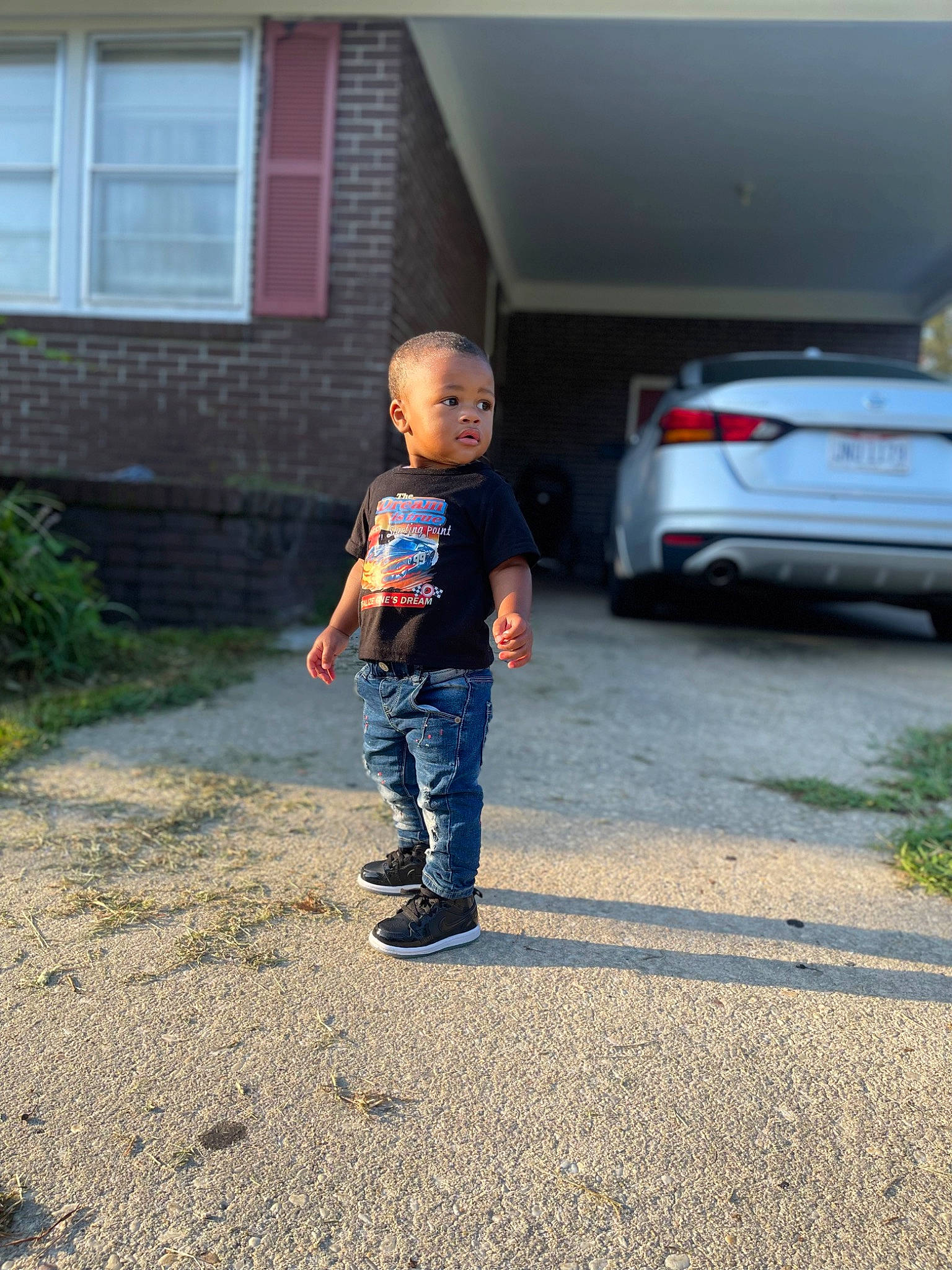 Sevyn is registered to the contest to win money with this photo: asphalt, automotive_exterior, automotive_lighting, car, door, grass, house, mammal, motor_vehicle, person, personal_luxury_car, plant, road_surface, rolling, standing, tire, toddler, tree, vehicle, vehicle_door