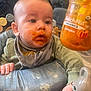 Oliver is registered to the contest to win money with this photo: baby, bib, child, clothing, container, curious, cute, face, feeding, food, hand, highchair, indoor, infant, jar, messy, orange, organics, pumpkin_puree, toy