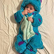 Oliver joined the competition — help win amazing prizes! baby, bed, blue, child, clothing, costume, cute, face, hand, infant, lying_down, onesie, plush, portrait, purple, sheet, soft, sucking_thumb, toy, warm