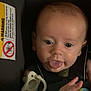 baby, tongue_out, car_seat, pacifier, blanket, child, infant, cute, face, hands, blue_blanket, warning_label, seatbelt, closeup, indoor, expression, young_child, playful, person, seat