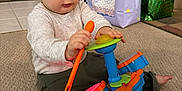 Kaiden joined the competition — help win amazing prizes! toddler, child, toy, drum_set, carpet, indoor, gift_bags, birthday, playing, floor, clothing, pants, long_sleeve, person, baby, cute, happy, home, celebration, music