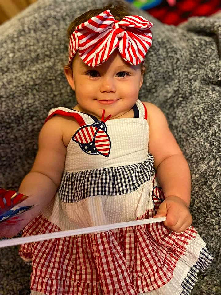 Magnolia is registered to the contest to win money with this photo: baby, baby_products, baby_toddler_clothing, cap, carmine, child, face, fashion_accessory, happy, head, headwear, joy, knit_cap, pattern, person, plaid, red, sleeve, textile, toddler