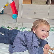Milhân participe au concours pour gagner de l'argent avec cette photo : toddler, child, baby, blanket, striped_shirt, indoor, floor, toy, playtime, curious, smiling, young_child, face, eyes, hair, crawling, furniture, cabinet, home, cute