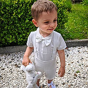 Adam Aaron Cooper a rejoint le concours — aidez-le/la à gagner de superbes lots ! bow_tie, child, cute, daylight, garden, greenery, happy, nature, outdoor, pebbles, playful, short_hair, smiling, standing, stuffed_animal, suspenders, toddler, white_bunny, white_clothing, white_shoes