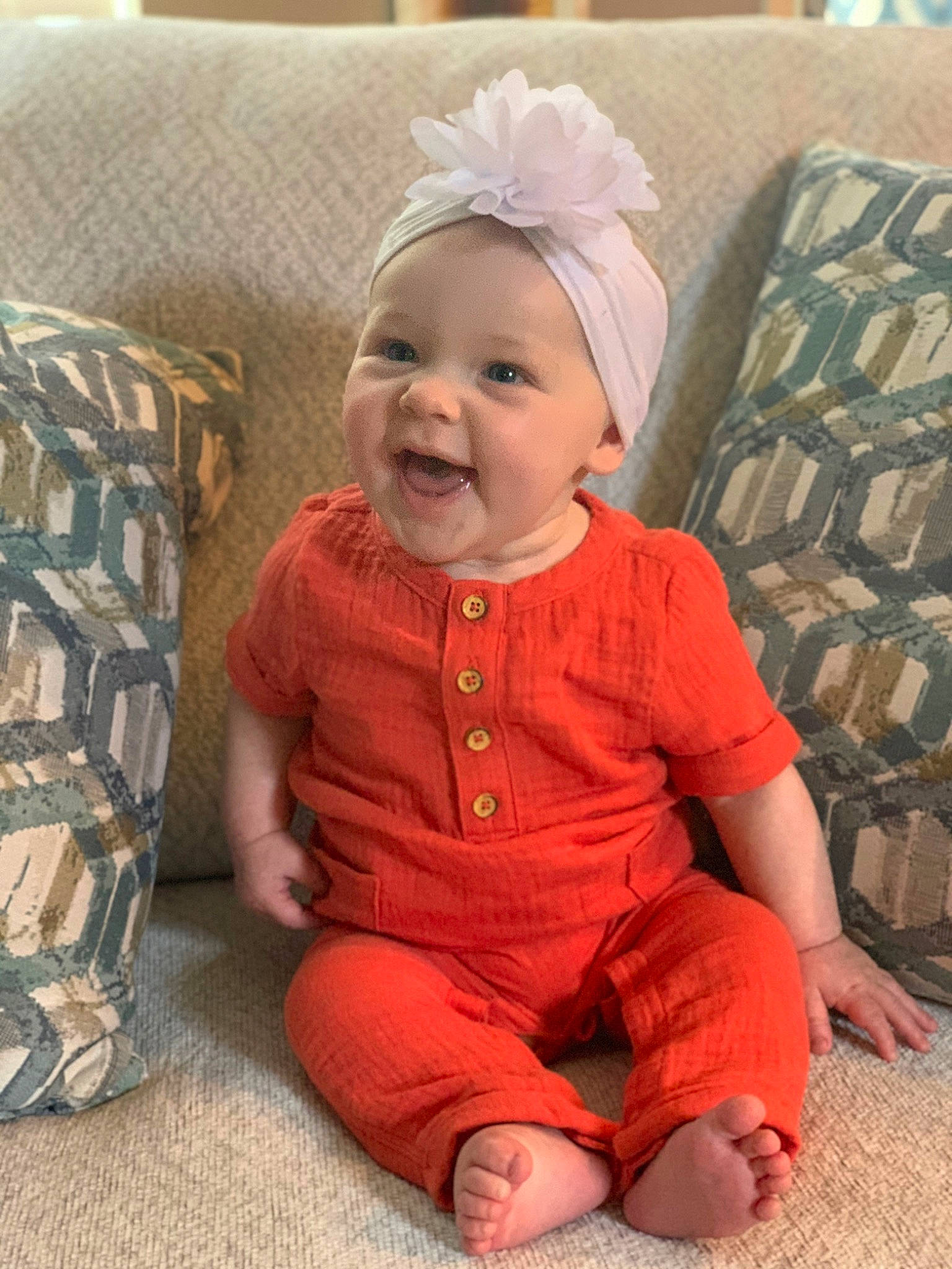 Saylor is registered to the contest to win money with this photo: baby, baby_toddler_clothing, cheek, child, ear, face, hair_accessory, head, headband, headgear, person, sitting, sleeve, smile, toddler