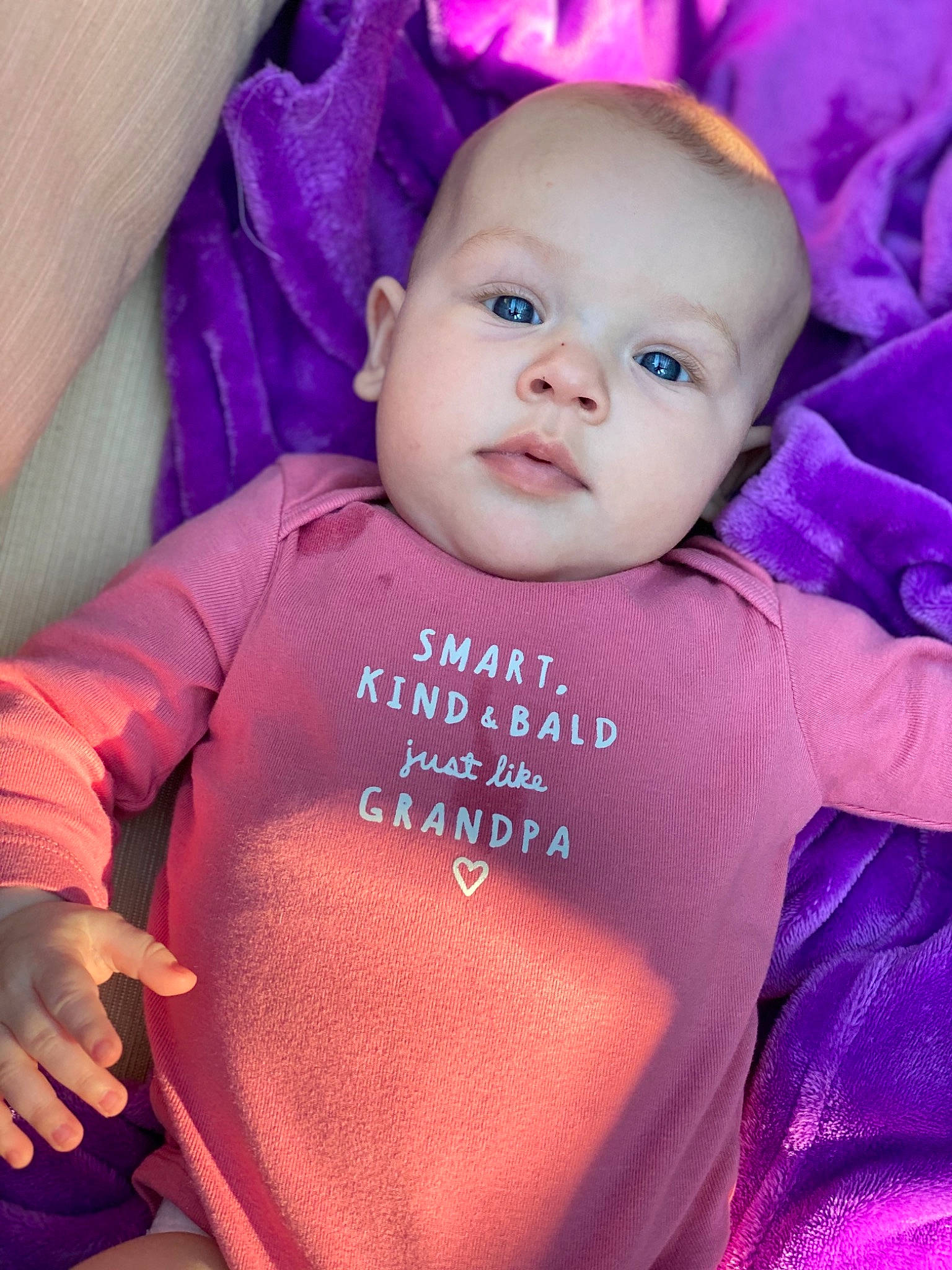 Saylor is registered to the contest to win money with this photo: baby, baby_products, baby_toddler_clothing, cheek, child, eye, face, happy, head, iris, lip, magenta, person, pink, product, purple, skin, sleeve, smile, toddler