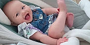 Raelyn joined the competition — help win amazing prizes! baby, infant, smiling, denim, romper, baby_seat, blanket, carpet, happy, cute, child, indoor, playful, legs, hand, clothing, face, person, cozy, home