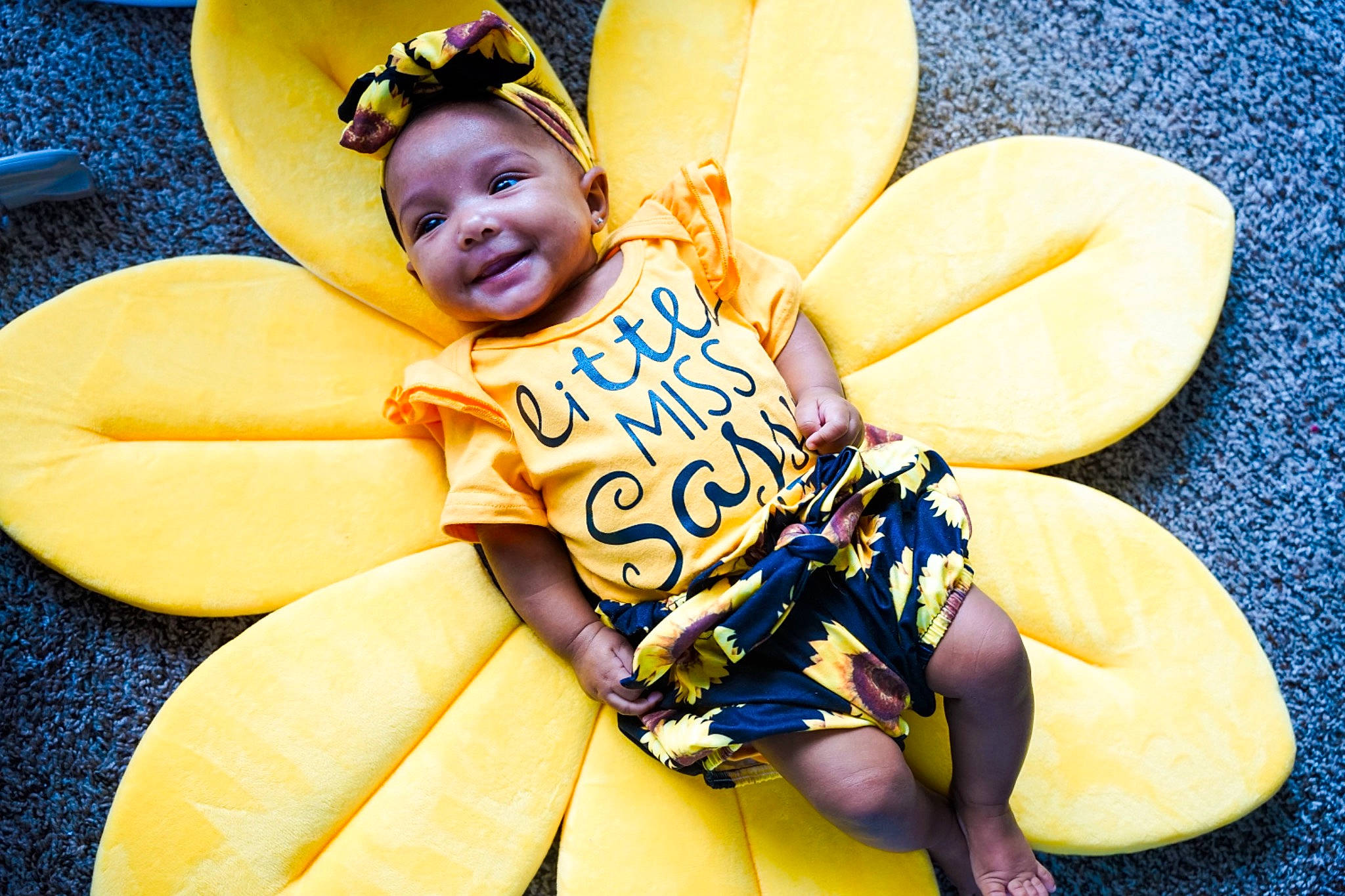 Demi joined the competition — help win amazing prizes! baby, baby_toddler_clothing, child, comfort, eye, fashion_accessory, fun, happy, hat, head, headgear, human_body, people_in_nature, person, plant, sitting, sun_hat, thigh, toddler, travel