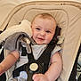 baby, smiling, stroller, harness, plush_toy, child, infant, clothing, seat, safety, cute, happy, portrait, indoors, comfort, face, hand, baby_girl, baby_boy, young_child