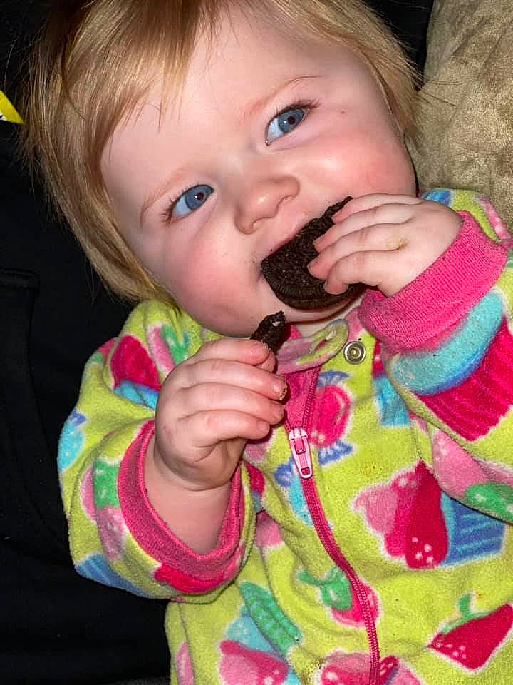 Khaleesi is registered to the contest to win money with this photo: baby, baby_toddler_clothing, baked_goods, biting, blond, cheek, child, dairy, dessert, eating, finger, food_craving, organ, person, pink, sweetness, taste, thumb, toddler, tongue