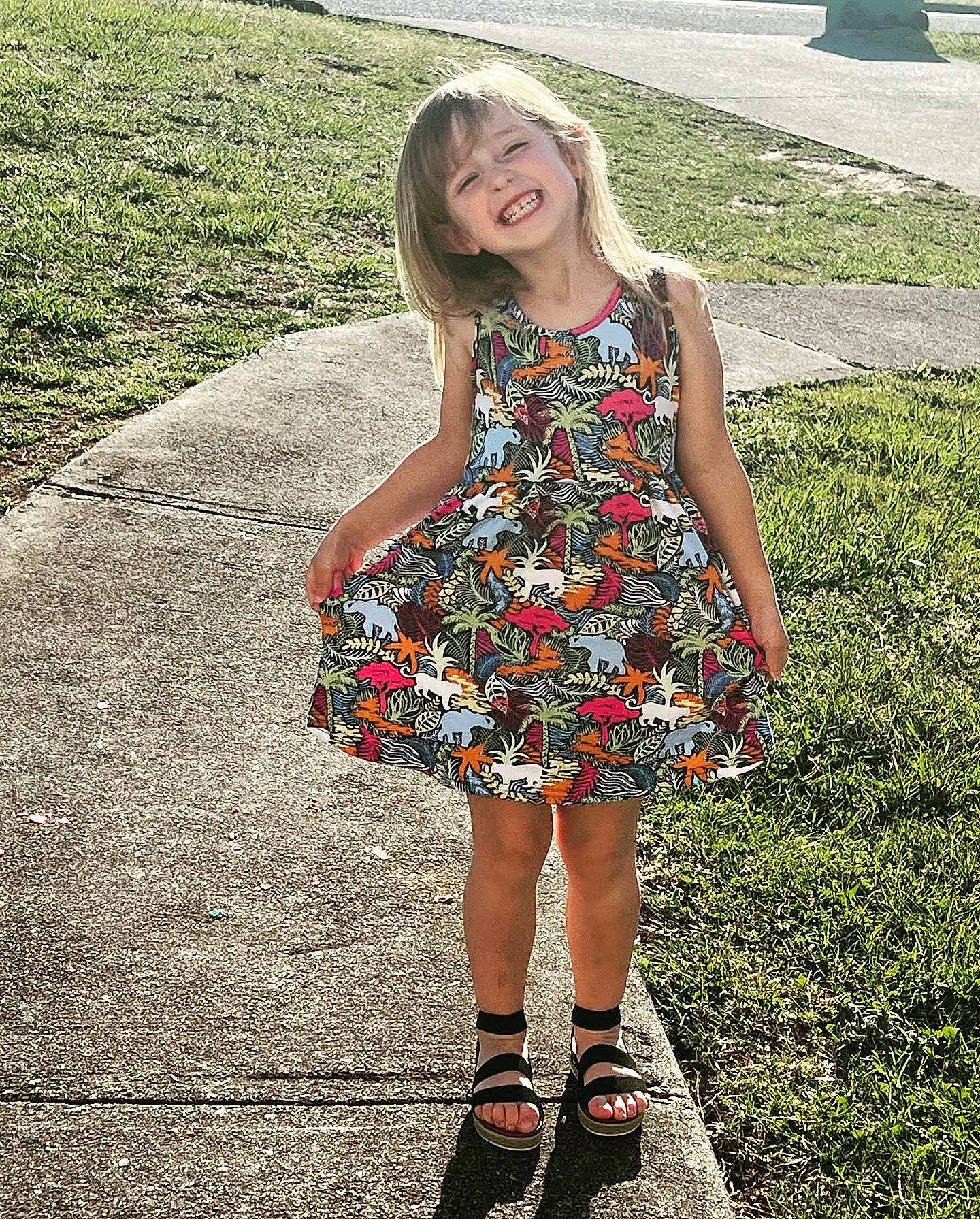 Nila is registered to the contest to win money with this photo: asphalt, day_dress, dress, electric_blue, grass, hair, happy, human_leg, joint, joy, knee, leg, one_piece_garment, pattern, people_in_nature, person, shoe, sleeve, smile, summer