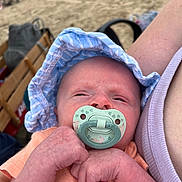 Theodore joined the competition — help win amazing prizes! baby, pacifier, hat, infant, hand, arm, person, beach, sand, clothing, closeup, portrait, skin, outdoor, sunhat, babyclothes, babyfist, relaxation, care, summer
