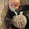 Theodore joined the competition — help win amazing prizes! baby, pacifier, infant, child, seat, baby_seat, straps, black_clothing, face, head, expression, wide_eyes, indoor, soft_texture, comfort, young, cute, person, baby_toy, closeup
