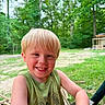 child, boy, blond_hair, smiling, outdoor, forest, greenery, tank_top, wood, nature, happy, face, person, daylight, casual, trees, background, playful, summer, dirt