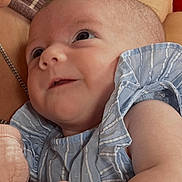Abigail is registered to the contest to win money with this photo: baby, infant, child, blue_striped_clothing, smiling, curious, portrait, closeup, skin, face, hand, arm, person, candid, indoor, soft_lighting, parent, love, care, tenderness