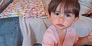Maélya participe au concours pour gagner de l'argent avec cette photo : bed, blanket, child, curly_hair, expression, eyes, face, furniture, hair, hand, indoor, person, pink_shirt, portrait, room, shelf, table, toddler, toy, wood