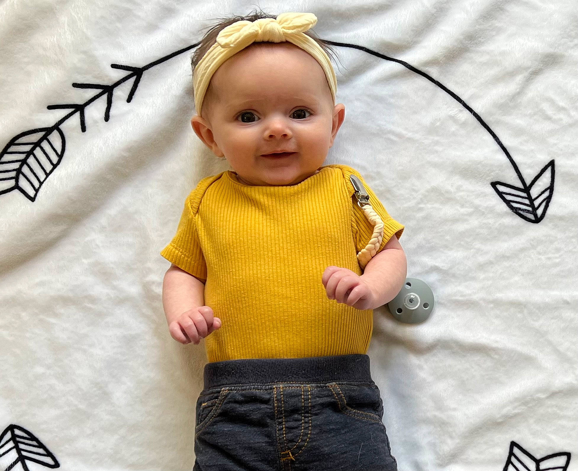 Sophia is registered to the contest to win money with this photo: arm, baby, baby_toddler_clothing, cheek, child, clothing, cool, face, finger, gesture, hand, happy, joy, outerwear, pattern, person, photograph, sleeve, t_shirt, textile