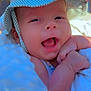 Ulysse a rejoint le concours — aidez-le/la à gagner de superbes lots ! baby, smiling, hat, striped_hat, blanket, outdoor, table, glass, happy, infant, closeup, face, skin, sunlight, hands, person, cute, cheerful, warm, daylight