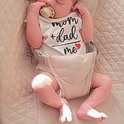 Ulysse a rejoint le concours — aidez-le/la à gagner de superbes lots ! baby, sleeping, pacifier, onesie, infant, child, cute, peaceful, resting, baby_seat, cushion, beige, soft_light, indoor, small_hands, small_feet, clothing, face, head, newborn