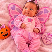 Ellie joined the competition — help win amazing prizes! antennae, baby, blanket, butterfly_costume, child, costume, halloween, headband, heart_sign, indoor, infant, onesie, pink, portrait, pumpkin, sitting, slippers, smiling, tutu, wings