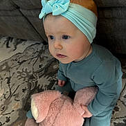 Lilliana joined the competition — help win amazing prizes! baby, child, pajamas, headband, bow, stuffed_animal, pink_bunny, toy, carpet, rug, couch, indoor, floor, curious, sitting, cute, infant, blue_eyes, soft_toy, home