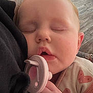 Lilliana joined the competition — help win amazing prizes! baby, sleeping, pacifier, face, hand, clothing, heart_pattern, closeup, infant, cozy, rest, child, soft_texture, skin, indoor, peaceful, toddler, cute, portrait, relaxation