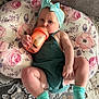 Lilliana joined the competition — help win amazing prizes! baby, child, headband, socks, sippy_cup, cushion, floral_pattern, carpet, couch, indoor, infant, person, cute, relaxed, clothing, floor, hand, face, legs, sitting