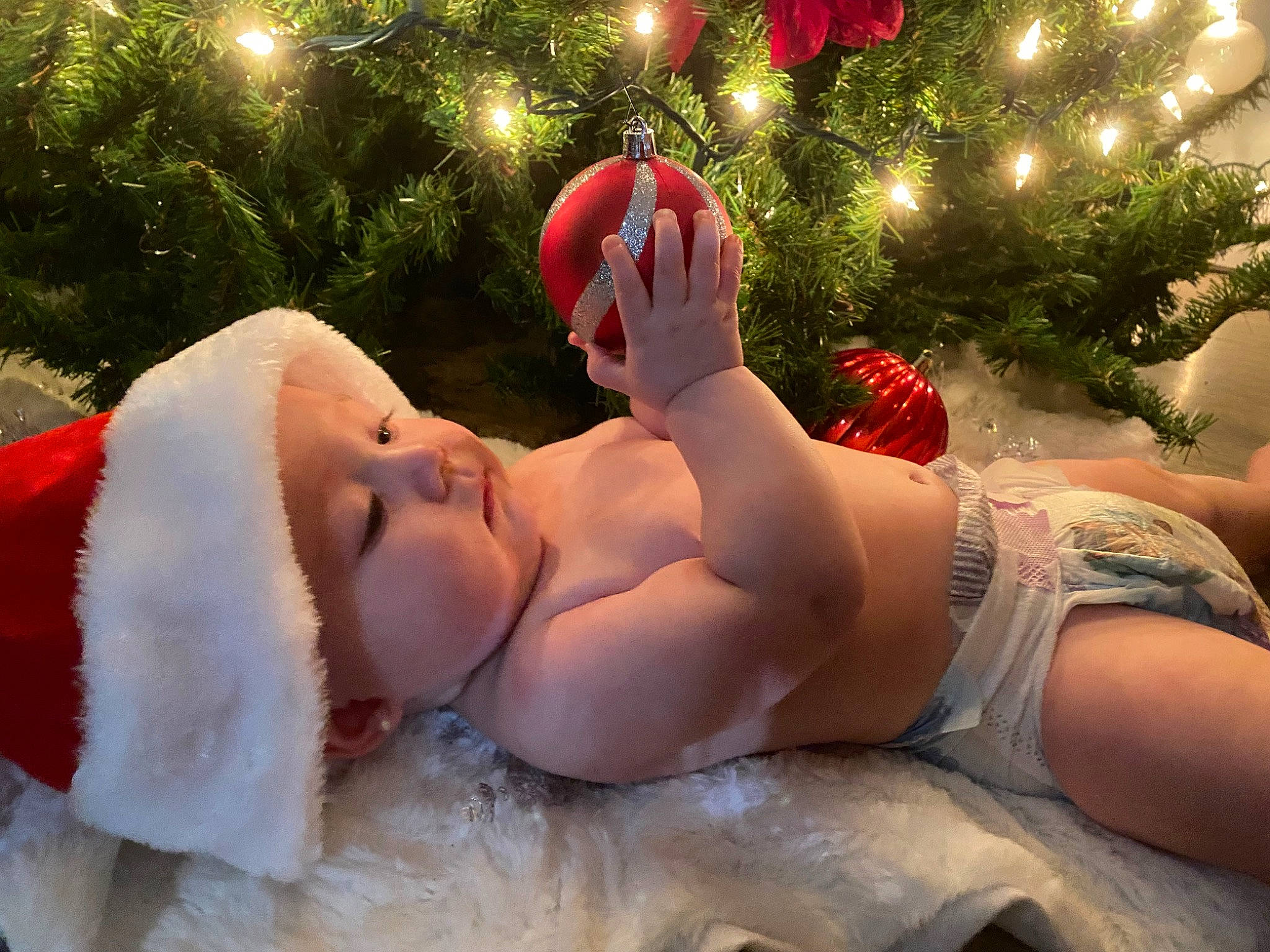 Kamiyah is registered to the contest to win money with this photo: abdomen, barechested, chest, event, foot, fun, gesture, grass, happy, head, headwear, human_leg, leisure, light, muscle, person, plant, smile, thigh, toddler