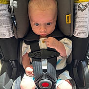 Myles is registered to the contest to win money with this photo: baby, car_seat, infant, child, safety_harness, seat_belt, cute, indoors, sunlight, shadow, clothing, person, seat, head_support, young_child, infant_clothing, baby_face, small_hands, car_interior, curious_expression