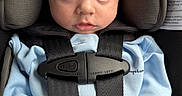 Myles is registered to the contest to win money with this photo: baby, child, car_seat, blue_clothing, blanket, infant, seatbelt, straps, face, head, hands, cushion, safety, indoors, person, portrait, young_child, cute, secure, closeup