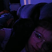 Rex a rejoint le concours — aidez-le/la à gagner de superbes lots ! animal, casual, closeup, companionship, couch, dim_light, dog, ear, face, friendship, glasses, home, indoor, person, pet, portrait, purple_light, relaxing, shadow, tshirt