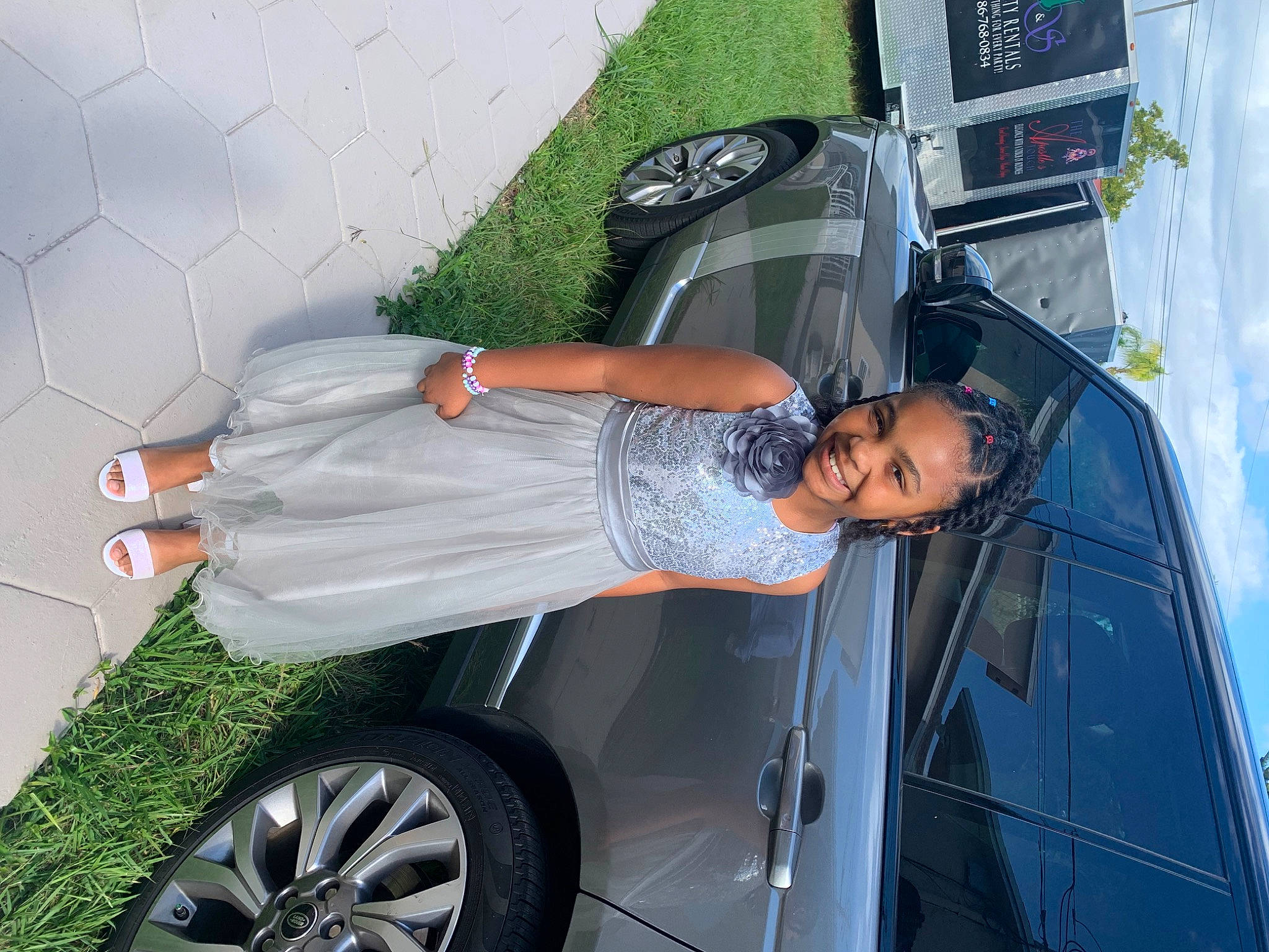 Shyla joined the competition — help win amazing prizes! alloy_wheel, automotive_design, automotive_exterior, automotive_lighting, automotive_tire, bumper, car, dress, hood, hubcap, joy, motor_vehicle, person, photograph, plant, rim, smile, tire, tread, vehicle