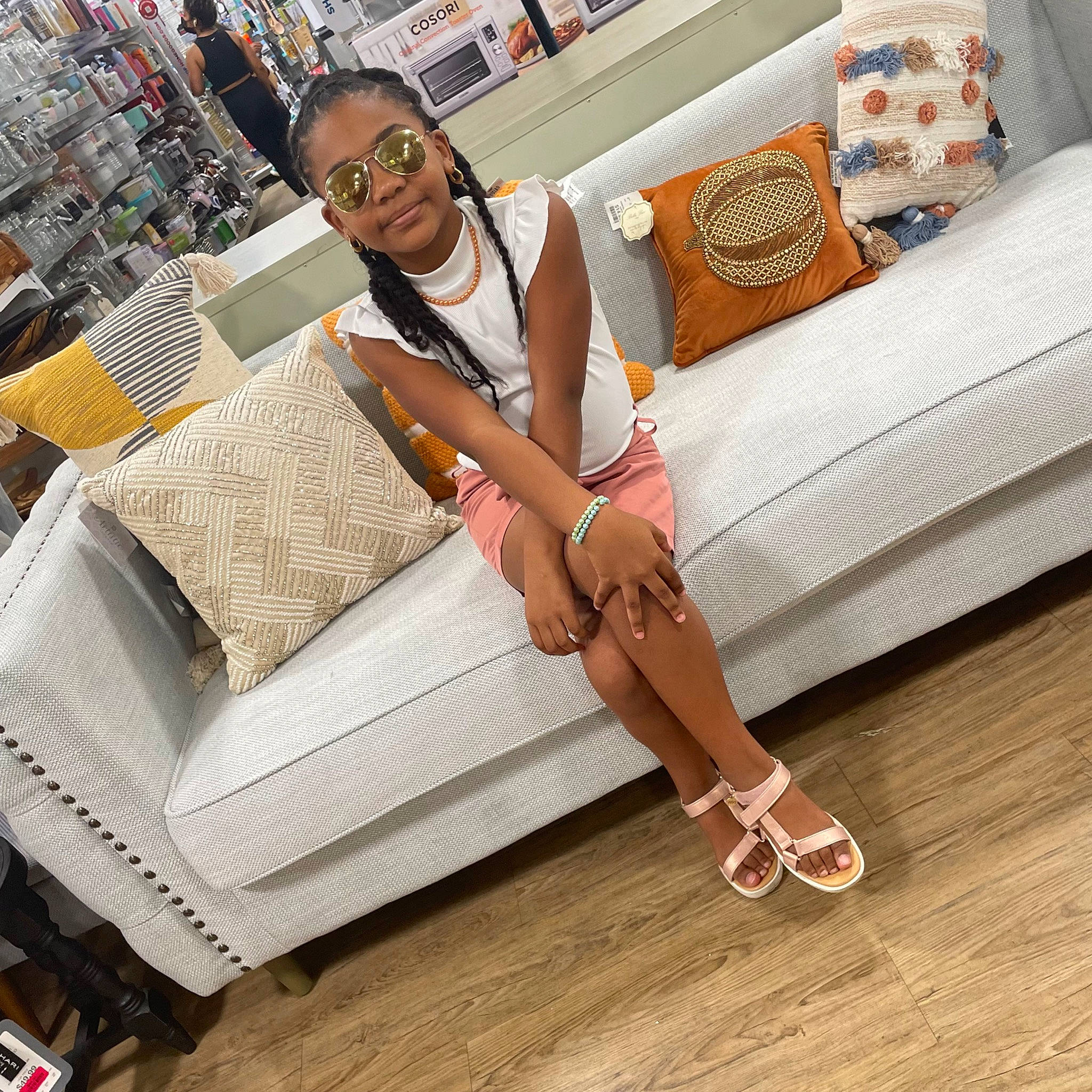 Shyla is registered to the contest to win money with this photo: automotive_design, comfort, couch, eyewear, fashion_accessory, fashion_design, flooring, foot, glasses, hardwood, human_leg, joy, knee, leisure, outdoor_furniture, person, sandal, studio_couch, sunglasses, thigh