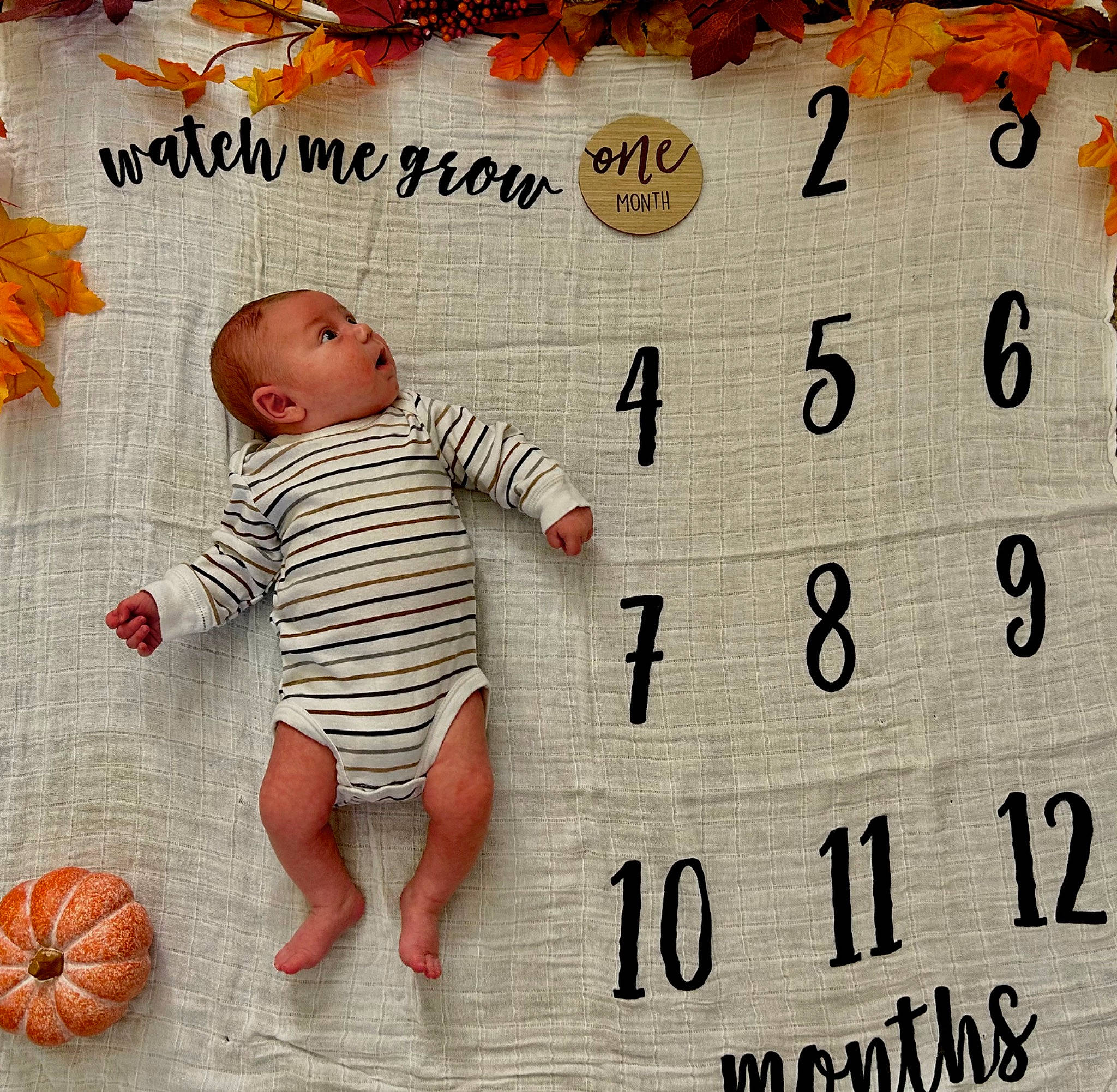 Lane is registered to the contest to win money with this photo: baby, baby_products, baby_sleeping, baby_toddler_clothing, ball, child, circle, font, happy, number, orange, pattern, peach, person, room, sleeve, smile, spider_man, stuffed_toy, surprise