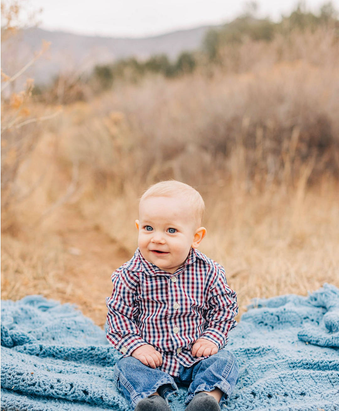 Forest is registered to the contest to win money with this photo: baby, baby_toddler_clothing, blue, child, flash_photography, fun, grass, happy, landscape, pattern, people_in_nature, person, plaid, portrait, portrait_photography, rock, sitting, toddler, tree, winter