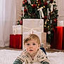toddler, child, baby, rug, christmas_tree, presents, holiday, decorations, indoors, sweater, cozy, festive, floor, young_child, cute, face, portrait, winter_wear, soft, home