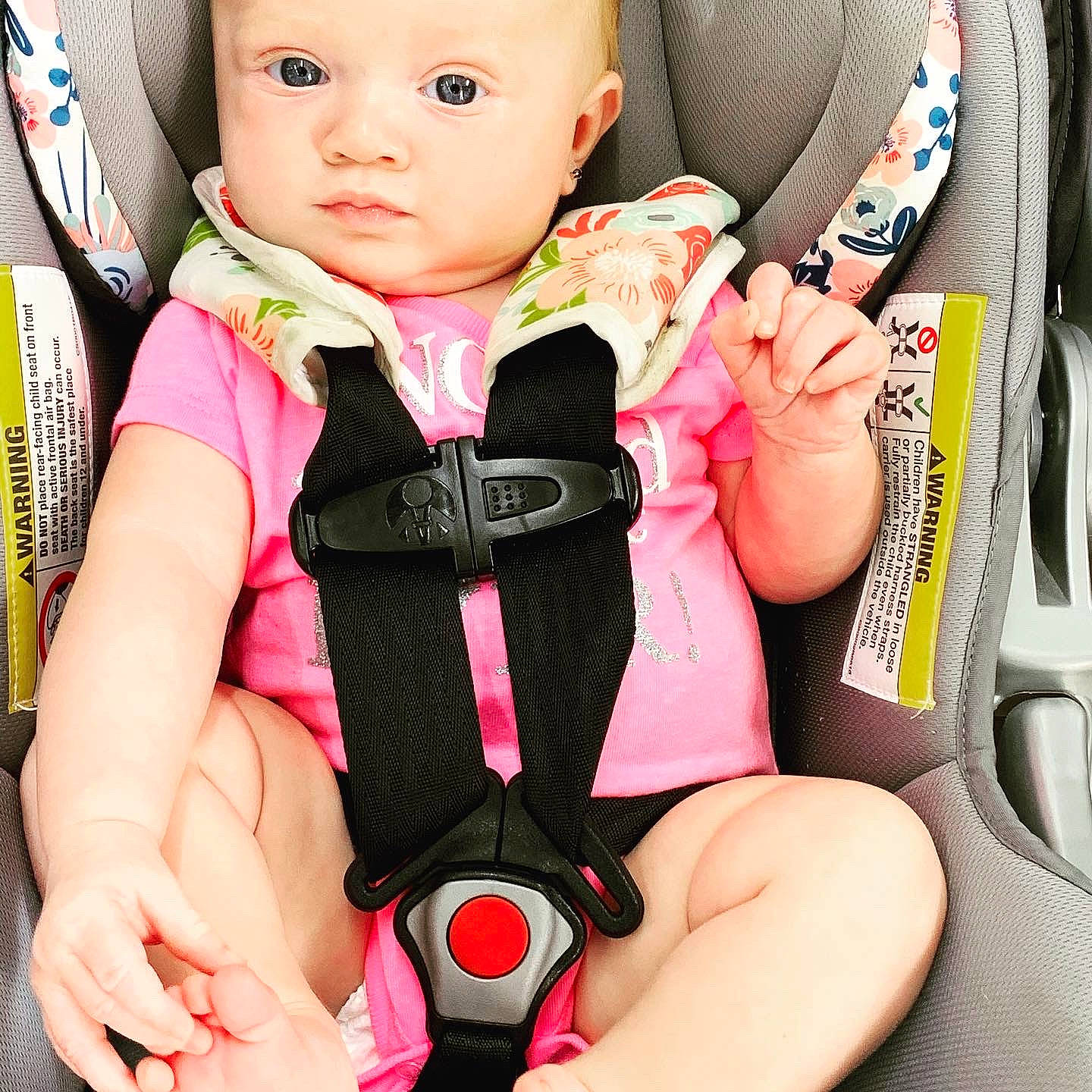 Cordelia is registered to the contest to win money with this photo: arm, baby, baby_in_car_seat, baby_safety, baby_toddler_clothing, car_seat, cheek, comfort, cool, face, facial_expression, finger, organ, person, pink, product, sleeve, thigh, thumb, toddler