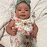 Jaylyn joined the competition — help win amazing prizes! adorable, baby, bow, child, closeup, curious_expression, cute, floral_outfit, headband, indoors, infant, lying_down, newborn, person, portrait, quilted_blanket, sleepwear, small_hands, soft_lighting, white_blanket