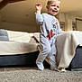 Noah a rejoint le concours — aidez-le/la à gagner de superbes lots ! toddler, child, smiling, indoors, carpet, blanket, couch, footed_pajamas, spiderman, happy, walking, living_room, furniture, person, cute, home, blond_hair, baby, cozy, soft_light