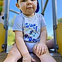 toddler, child, boy, cap, blue_cap, shirt, surf_vibes, slide, playground, outdoor, daylight, hands, legs, face, looking, sitting, smiling, cute, casual_clothing, young_child