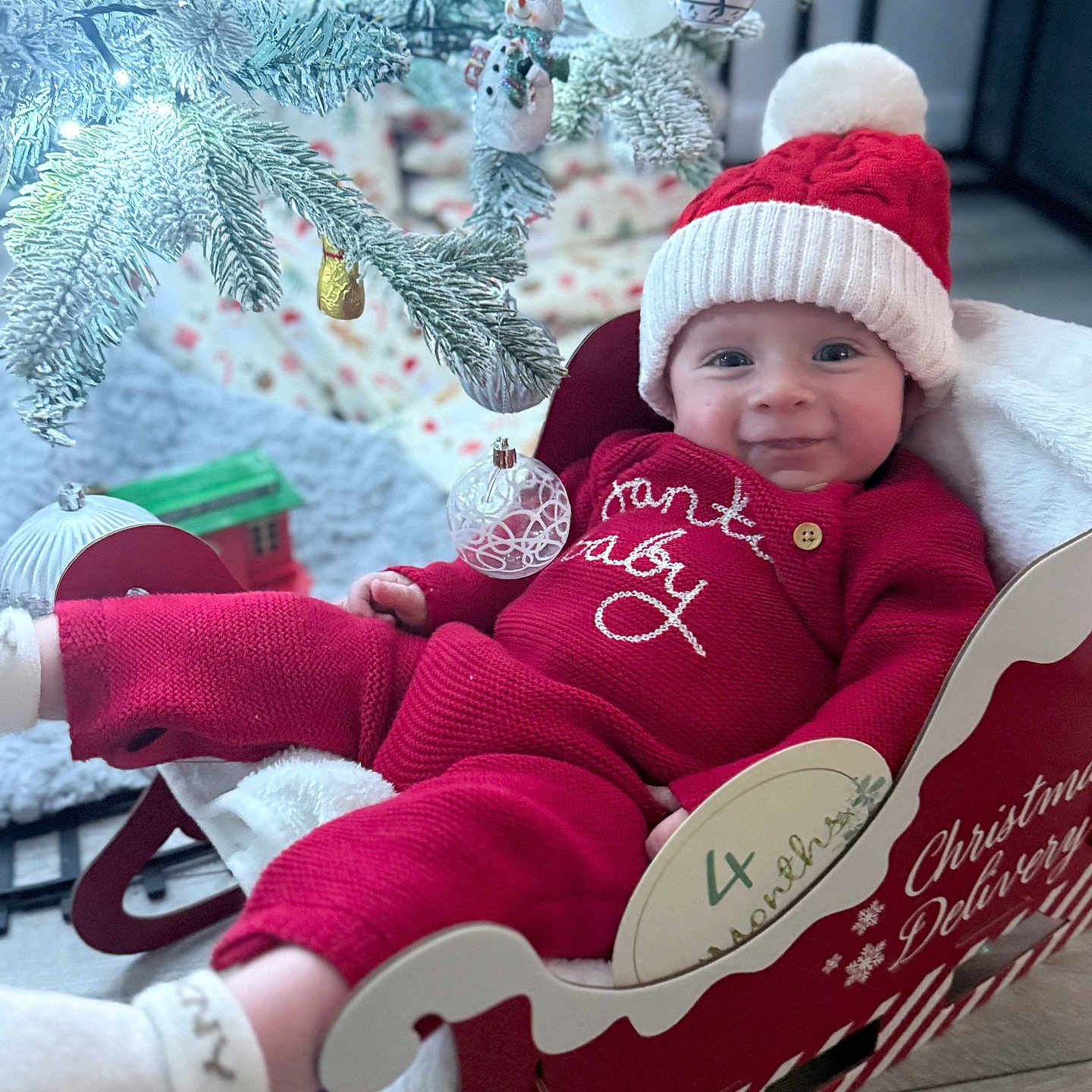 Theo joined the competition — help win amazing prizes! baby, beanie, bonnet, cap, christmas, christmasdecorations, clothing, coat, costume, couch, face, festival, furniture, hat, head, knitwear, person, photography, portrait, sweater
