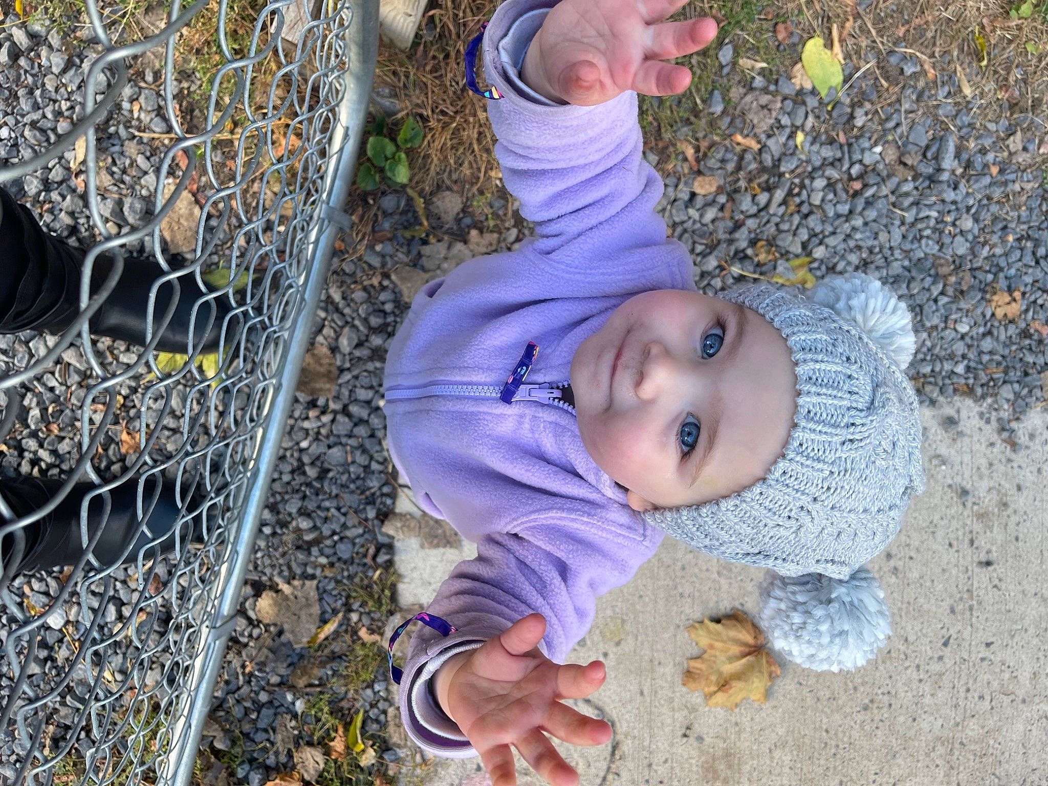 Khalani is registered to the contest to win money with this photo: baby, baby_toddler_clothing, chain_link_fencing, child, electric_blue, fence, fun, grass, hat, headwear, mesh, net, pattern, people_in_nature, person, plant, play, soil, toddler, tree