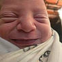 Tyler is registered to the contest to win money with this photo: baby, newborn, close_up, face, smile, wrapped, blanket, infant, cute, skin, expression, peaceful, soft, young, portrait, indoors, person, head, sleepy, newborn_baby